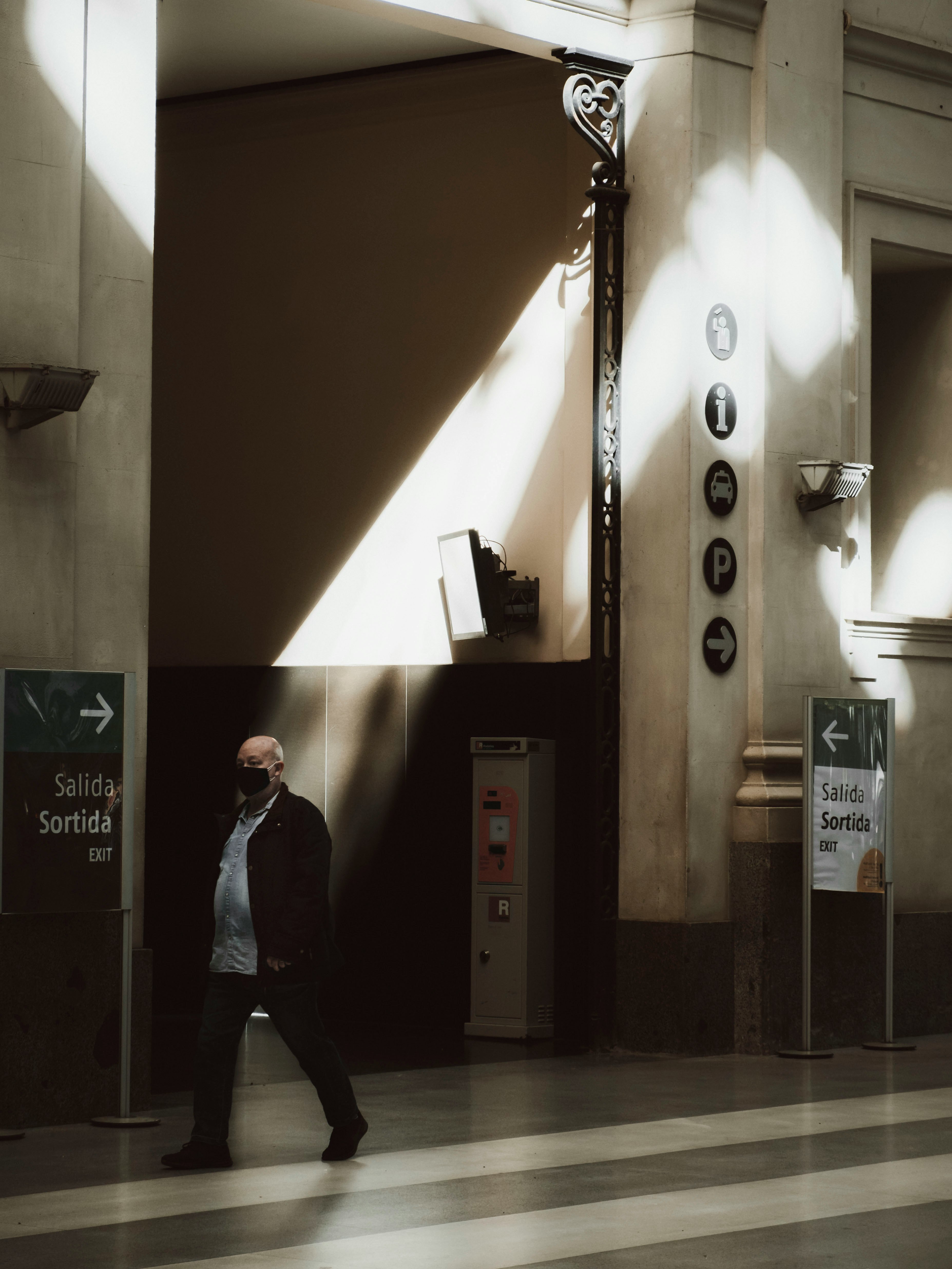 woman in black jacket standing near door